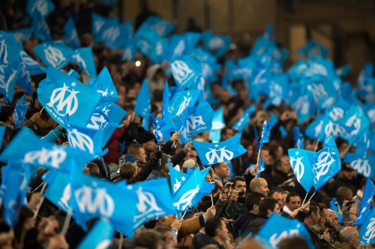 Marseille's fans wave flags prior to the French L1 football match Olympique de Marseille vs AS Monaco on November 29, 2015 at the Velodrome stadium in Marseille, southern France