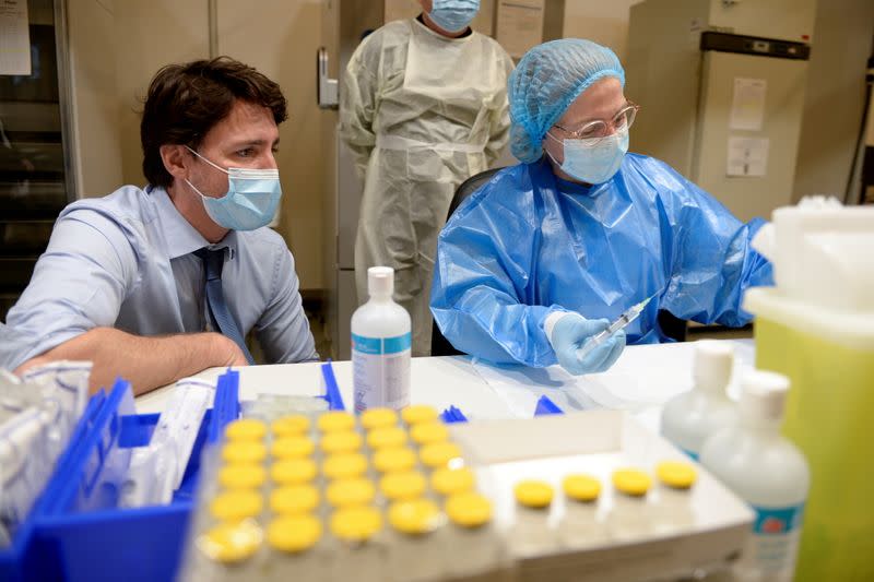 FILE PHOTO: Canada's Prime Minister Trudeau visits a vaccination clinic in Montreal