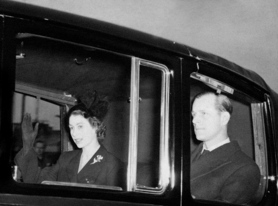 1952: The new Queen, Elizabeth II (formerly Princess Elizabeth), returns to Clarence House, London, with the Duke of Edinburgh from London Airport after the sudden death of her father, King George VI. She succeeded the King on his death a day earlier (PA)