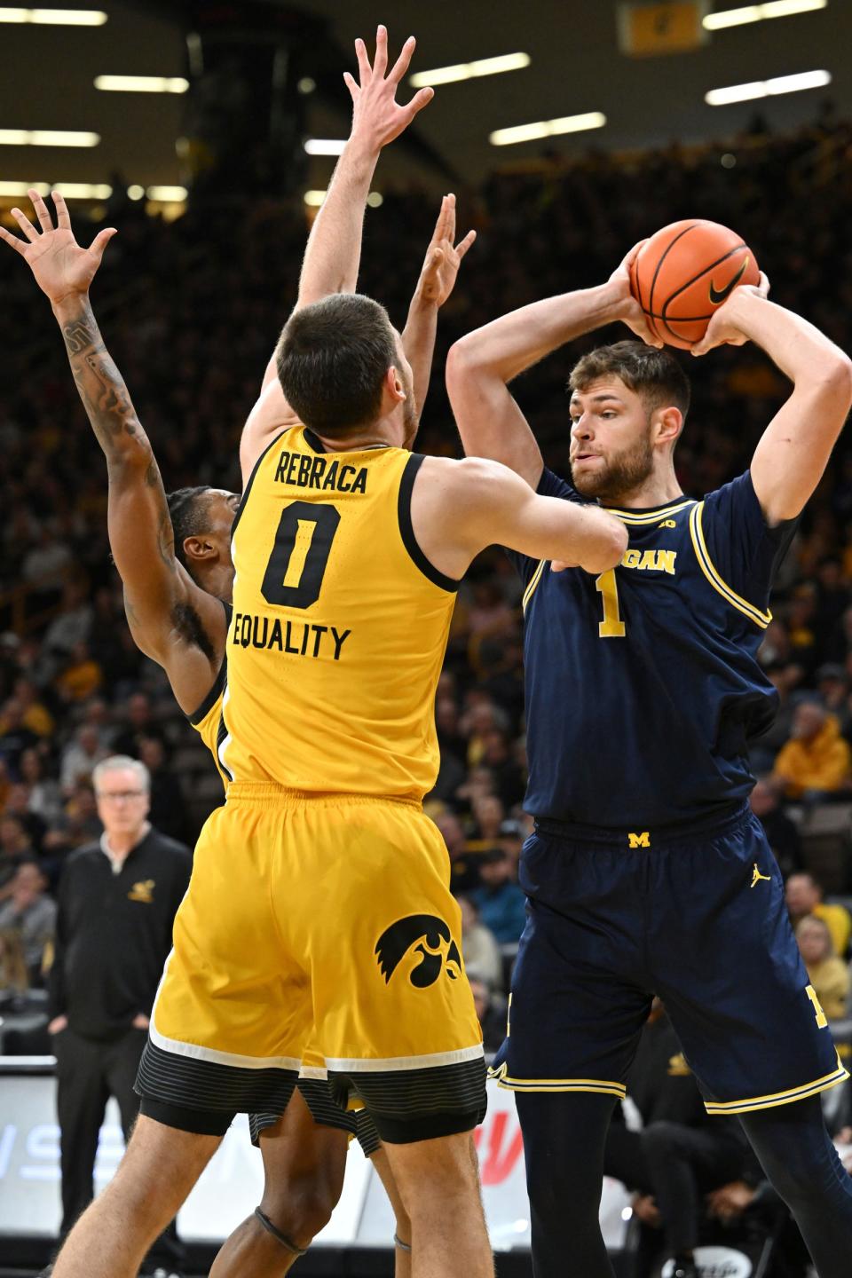 Michigan center Hunter Dickinson is defended by Iowa forward Filip Rebraca, center, and guard Ahron Ulis during the first half on Thursday, Jan. 12, 2023, in Iowa City, Iowa.