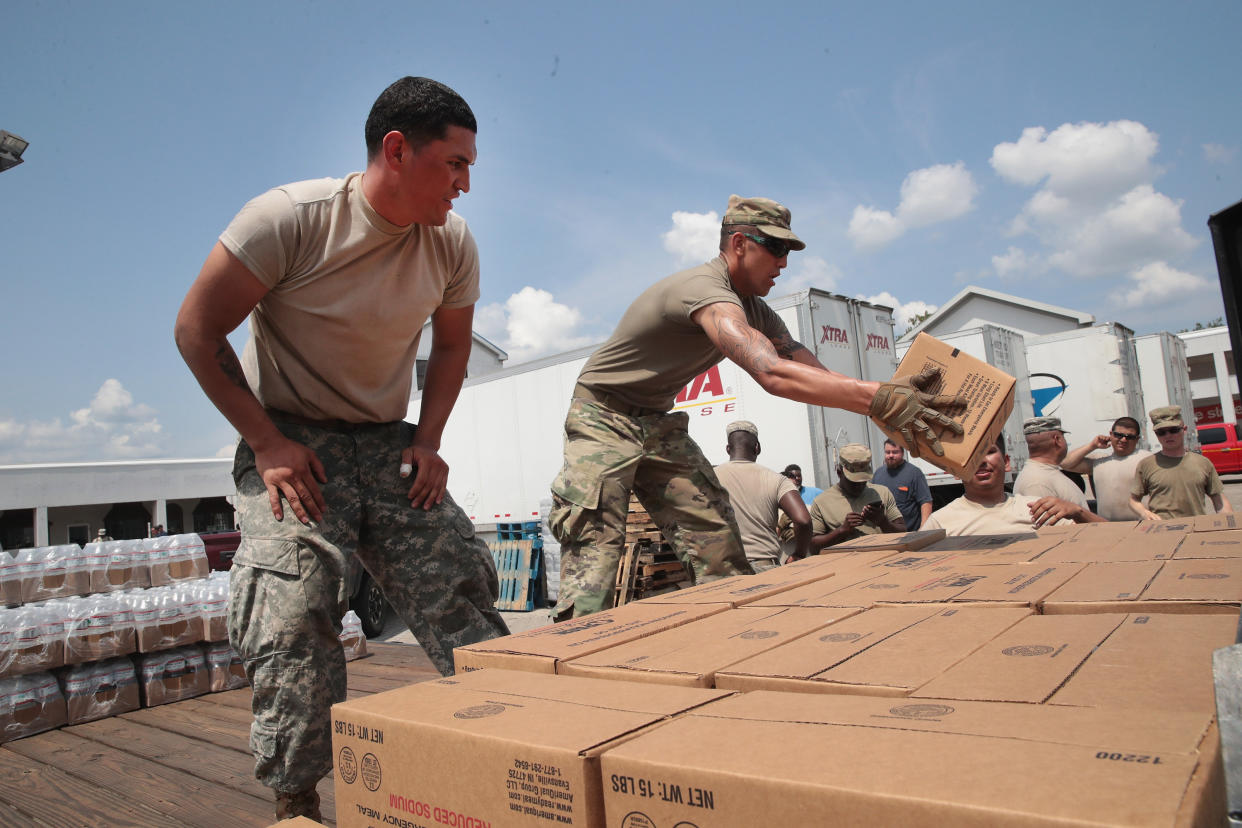 Members of the Texas Army National Guard from El Paso, Texas distribute food and water to flood victims in Orange, Texas, (Photo: Scott Olson via Getty Images)