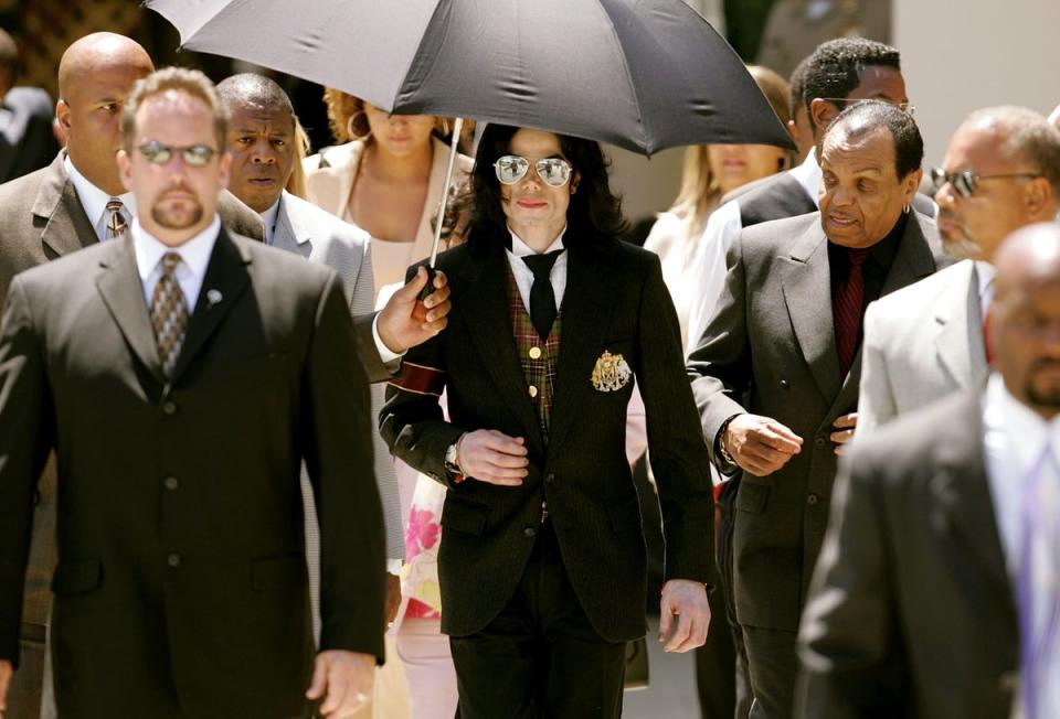 Jackson and his father Joseph leave the courthouse after listening to closing arguments in the singer’s child molestation trial, at the Santa Barbara County Courthouse on 2 June 2005 (Getty)