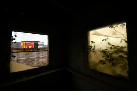 Billboards are viewed from inside a disused customs hut on the border in Carrickcarnon, Northern Ireland, December 7, 2017. REUTERS/Clodagh Kilcoyne