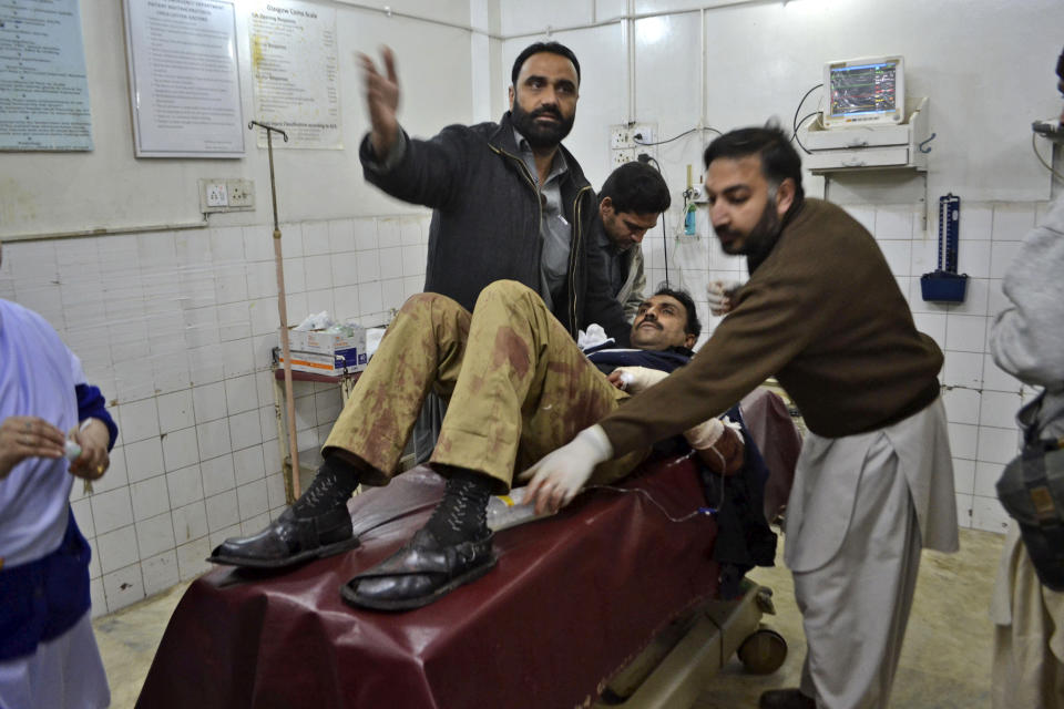 A Pakistani policeman, who was injured in a bomb explosion in Charsadda, is brought to a hospital in Peshawar, Pakistan, Wednesday, Jan. 22, 2014. A bomb rigged to a bicycle struck a police patrol on its way to guard a polio vaccination team in northwestern Charsadda district, killing six, said officer Shafiullah Khan. (AP Photo/Mohammad Sajjad)