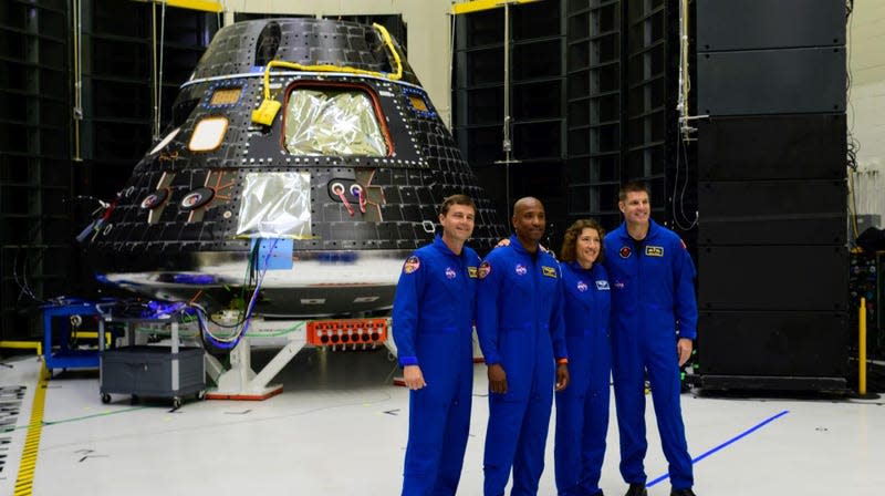 The Artemis 2 crew posing in front of the Orion spacecraft.