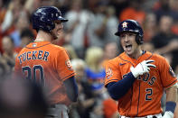 Houston Astros' Alex Bregman (2) celebrates with Kyle Tucker (30) after hitting a home run against the Tampa Bay Rays during the first inning of a baseball game Friday, Sept. 30, 2022, in Houston. (AP Photo/David J. Phillip)