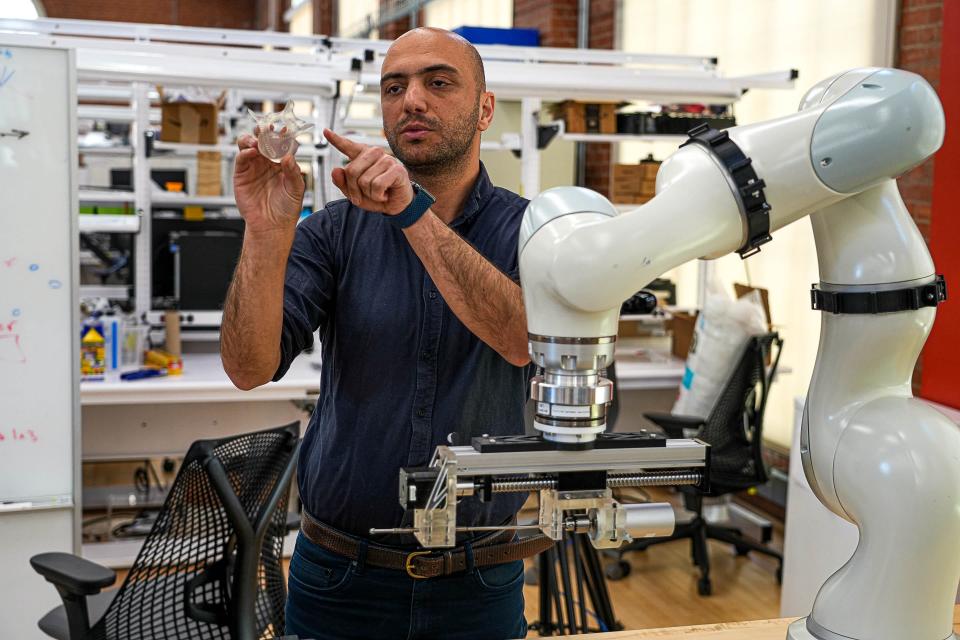 Farshid Alambeigi, an associate professor, holds up a simulated vertebrae in the Advanced Robotic Technologies for Surgery lab.