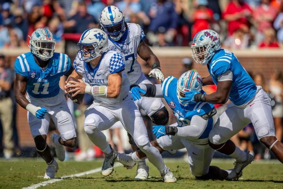 Kentucky quarterback Will Levis (7) tries to escape pressure from Ole Miss defenders on Saturday. Levis, who lost two late fumbles in the loss, has been sacked 19 times this season.