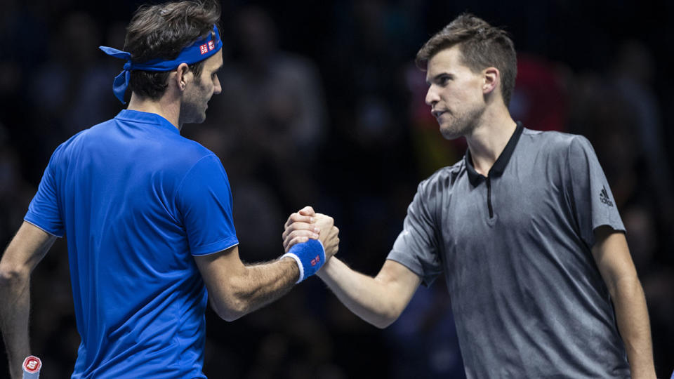 Dominic Thiem shakes hands with Roger Federer. (Photo by Fred Lee/Getty Images)