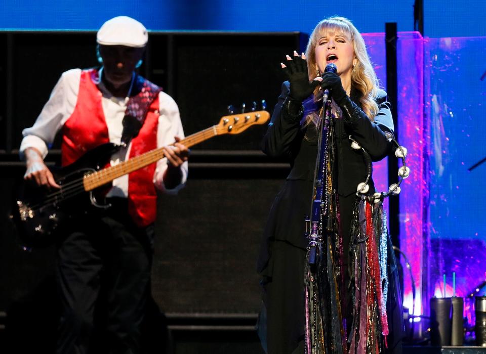 Stevie Nicks, right, sings alongside bassist John McVie as Fleetwood Mac performs at Chesapeake Energy Arena in Oklahoma City, Friday, April 17, 2015.