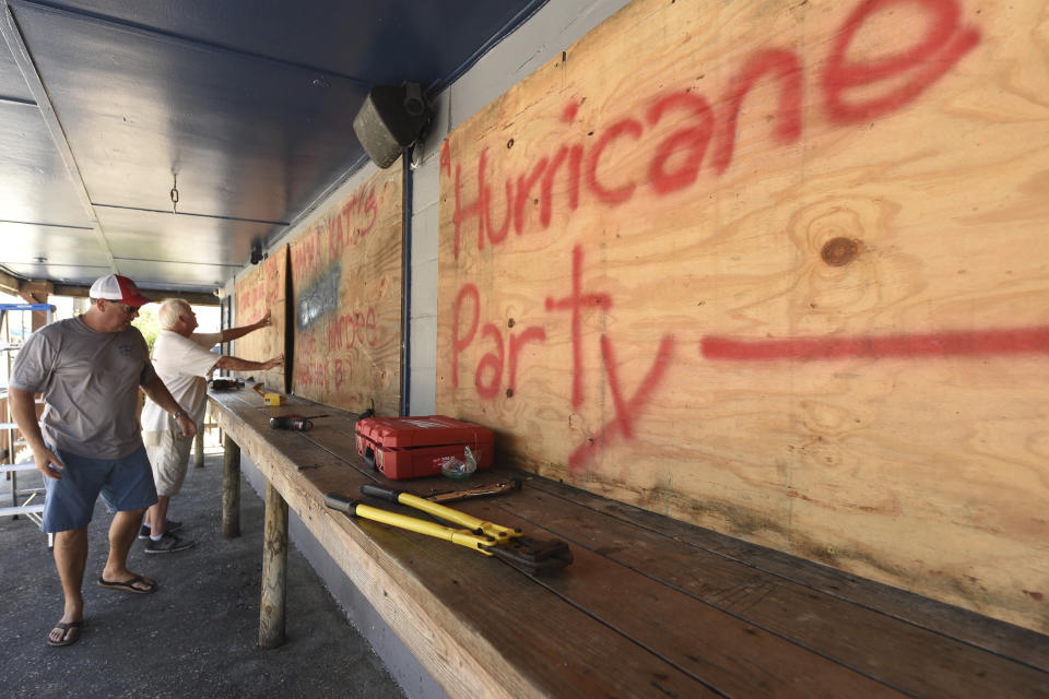 Jim Carter and Rob Quinn board up Lagerheads Tavern in Wrightsville Beach, N.C. as they prepare for Hurricane Florence Monday, Sept. 10, 2018. Hurricane Florence now a category 3 hurricane is expected to make land fall somewhere along the North Carolina coastline towards the end of the week. (Ken Blevins /The Star-News via AP)