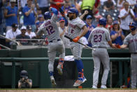 New York Mets' Francisco Lindor (12) celebrates his two-run home run with Dominic Smith (2) during the fifth inning of the first baseball game of a doubleheader, Saturday, June 19, 2021, in Washington. This is a makeup of a postponed game from April 1. (AP Photo/Nick Wass)