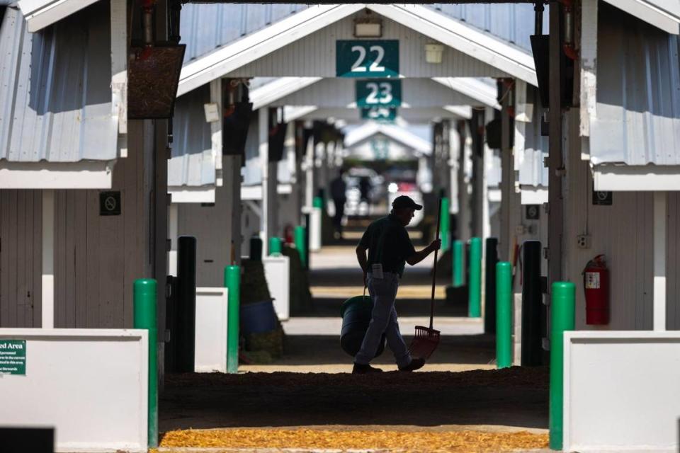 A worker walks through the barn area on the opening day of the Keeneland Fall Meet on Friday. Ryan C. Hermens/rhermens@herald-leader.com