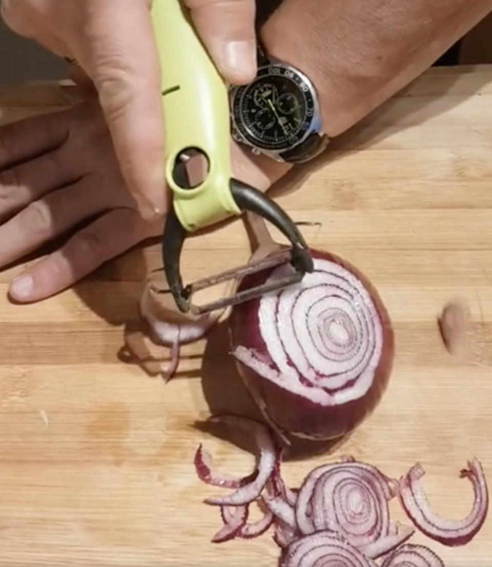 person peeling an onion