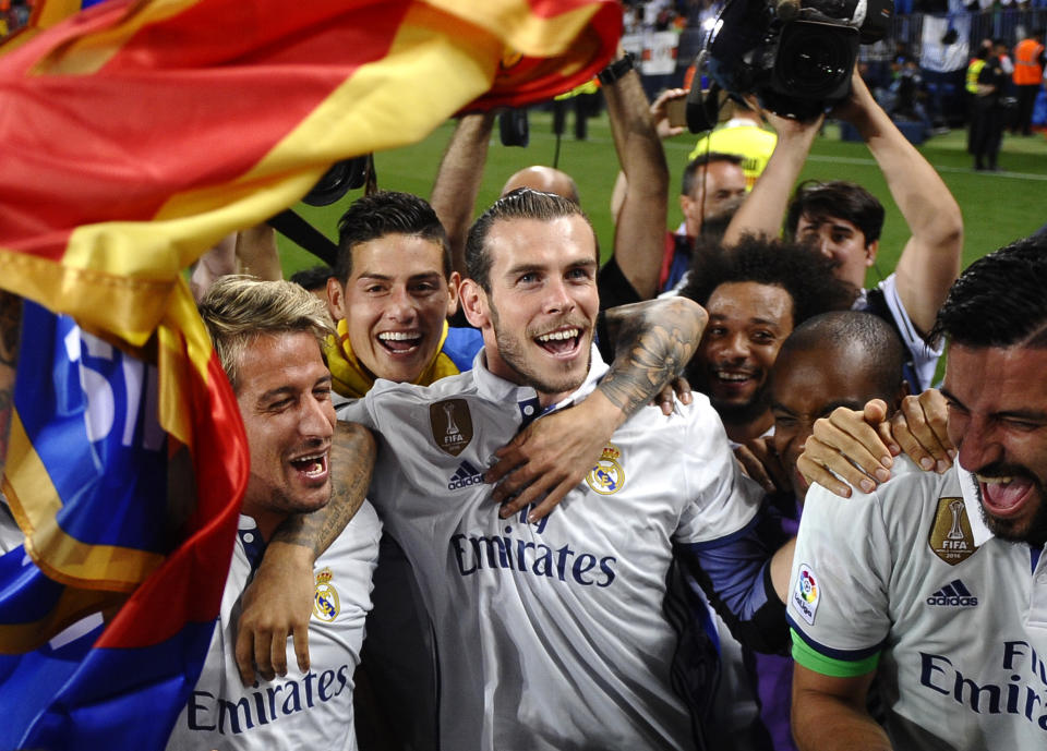FILE - Real Madrid's Gareth Bale celebrates with teammates at the end of a Spanish La Liga soccer match between Malaga and Real Madrid in Malaga, Spain, Sunday, May 21, 2017. Real Madrid wins the Spanish league for the first time in five years, avoiding its biggest title drought since the 1980s. (AP Photo/Daniel Tejedor, File)