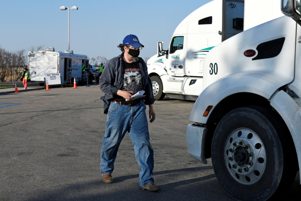 <p>A Canadian truck driver walks back to his truck after receiving a COVID-19 vaccine at a rest stop near Drayton, North Dakota, April 22, 2021. Manitoba-based truckers, transporting goods to and from the United States, are being vaccinated against coronavirus disease (COVID-19) as part of a deal between the Canadian province and the state of North Dakota. REUTERS/Dan Koeck</p> 