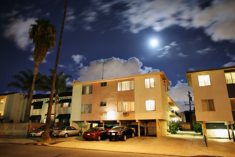 Residential street with dingbat apartment buildings at night in Los Angeles, California.