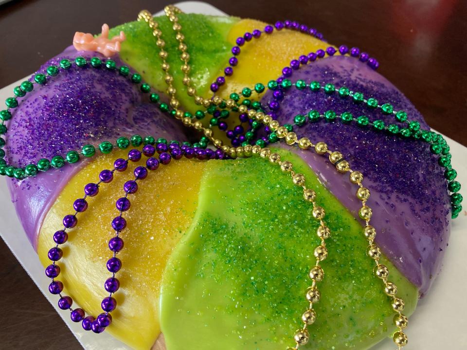 A freshly made king cake from Liger's Bakery in Montgomery, Alabama, is decorated with beads and ready for Mardi Gras.