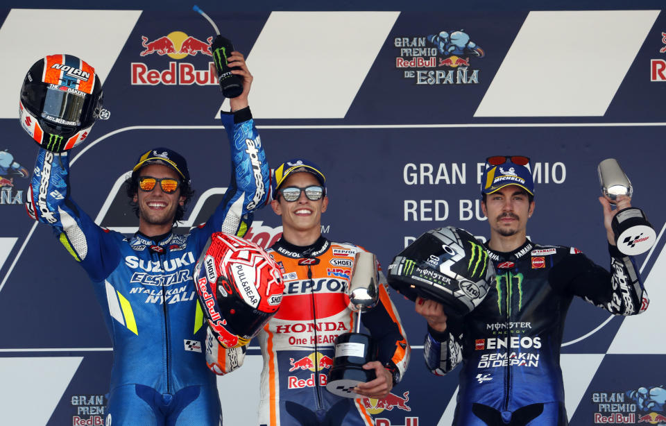 Second placed Alex Rins of Spain, winner Marc Marquez of Spain and third placed Maverick Vinales of Spain, from left to right, on the podium of the MotoGP race of the Spanish Motorcycle Grand Prix at the Angel Nieto racetrack in Jerez de la Frontera, Spain, Sunday, May 5, 2019. (AP Photo/Miguel Morenatti)