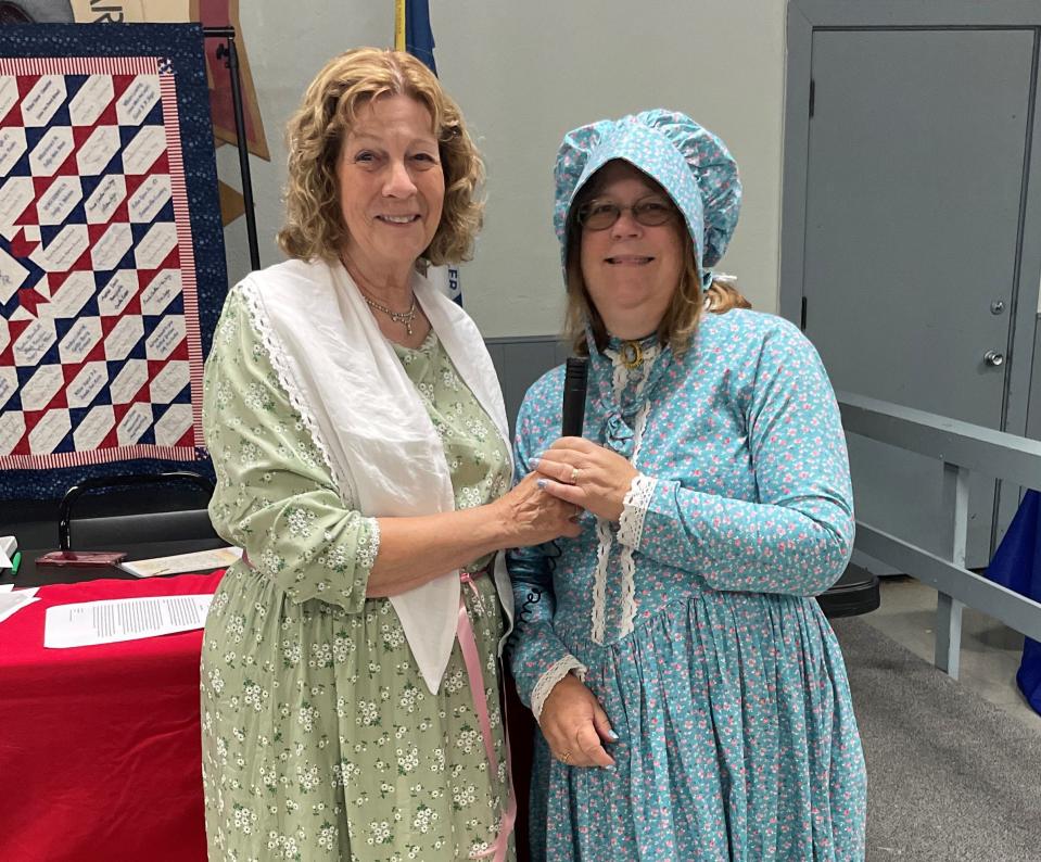 A reporter (Nancy Lori) interviews Mary Donoho (Kim Stickland) as part of a skit during the Holland DAR Chapter's bicentennial celebration of the Santa Fe Trail.