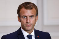 French President Emmanuel Macron looks on during the signing of a new defense deal at The Elysee Palace Tuesday, Sept. 28, 2021 in Paris. France and Greece announced on Tuesday a major, multibillion-euro defense deal including Athens' decision to buy three French warships. (Ludovic Marin, Pool Photo via AP)