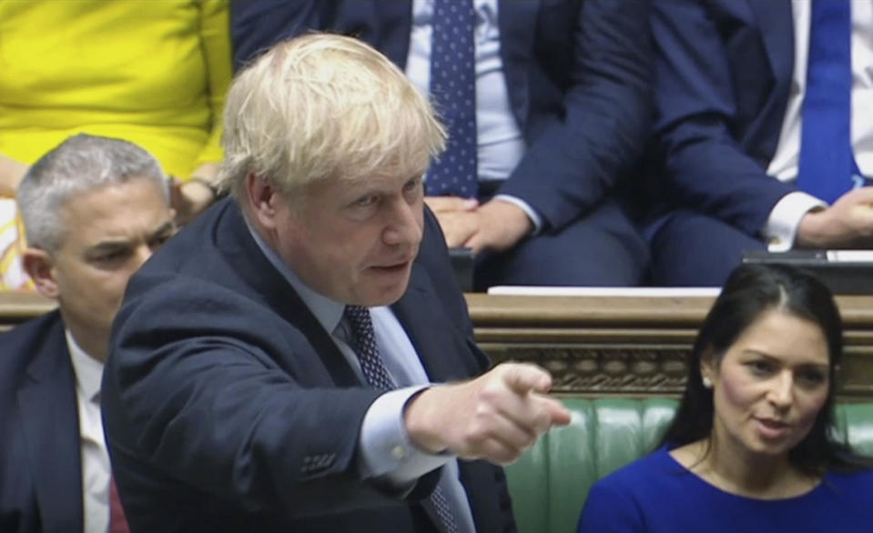 Britain's Prime Minister Boris Johnson speaks during a debate inside the House of Commons in London, Saturday Oct. 19, 2019. At a rare weekend sitting of Parliament, Johnson implored legislators to ratify the Brexit deal he struck this week with the other 27 EU leaders. (House of Commons via AP)