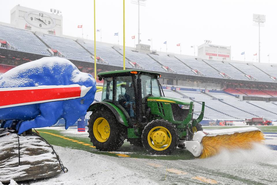 Stadium staff removes snow from the field at Highmark Stadium prior to the game last season against the Atlanta Falcons.