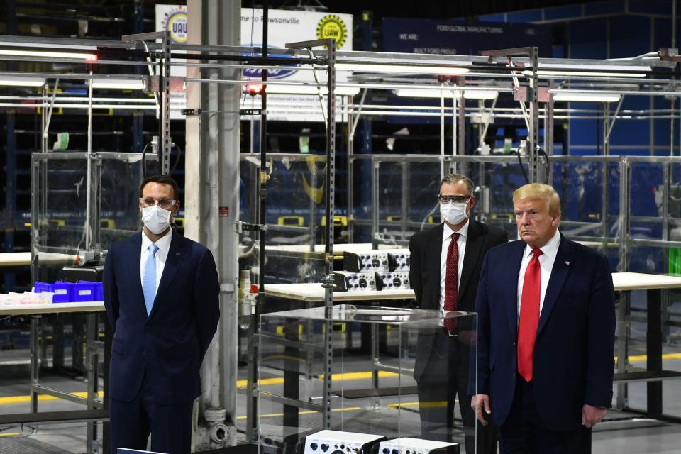 US President Donald Trump (R) tours the Ford Rawsonville Plant, that has been converted to making personal protection and medical equipment, in Ypsilanti, Michigan on May 21, 2020. (Photo by Brendan Smialowski / AFP) (Photo by BRENDAN SMIALOWSKI/AFP via Getty Images) ORIG FILE ID: AFP_1S135B