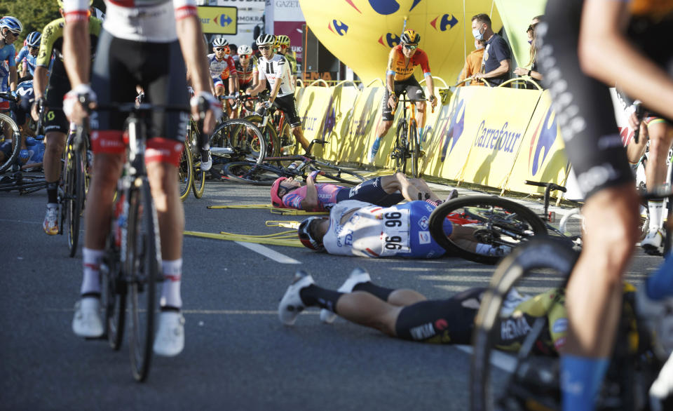 Cyclists are injured in a crash on the final stretch of the opening stage of the Tour de Pologne race in Katowice, Poland, on Wednesday, Aug. 5, 2020. The crash began with a high-speed collision between two Dutchmen sprinting for the win, Fabio Jakobsen and Dylan Groenewegen. Jakobsen was hospitalized in serious condition and put into an induced coma. He was declared the winner of the opening stage and Groenewegen was disqualified after the crash. (AP Photo)