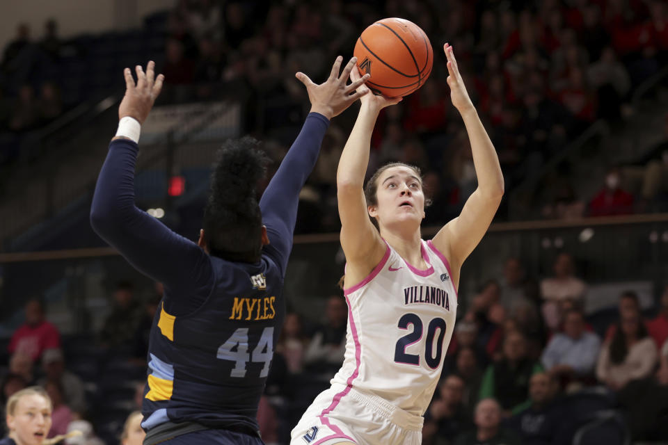 FILE - Villanova's Maddy Siegrist (20) shoots over Marquette's Kennedi Myles of Marquette during the first half of an NCAA college basketball game, Feb. 1, 2023, in Villanova, Pa. For nearly 30 minutes Siegrist signed autographs and took selfies with adoring young fans in New York after she helped the No. 14 Wildcats beat St. John's on Wednesday, Feb. 16.(Charles Fox/The Philadelphia Inquirer via AP, File)