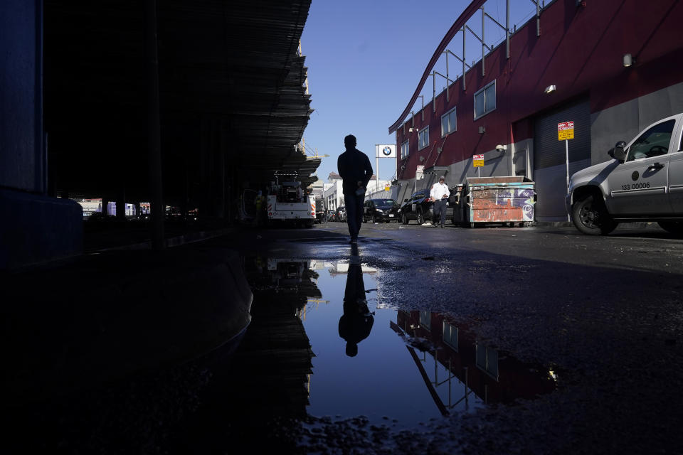 Francis Zamora, of Department of Emergency Management, walks past a puddle near a homeless encampment being cleaned up in San Francisco, Tuesday, Aug. 29, 2023. Cities across the U.S. are struggling with and cracking down on tent encampments as the number of homeless people grows, largely due to a lack of affordable housing. Homeless people and their advocates say sweeps are cruel and costly, and there aren't enough homes or beds for everyone. (AP Photo/Jeff Chiu)