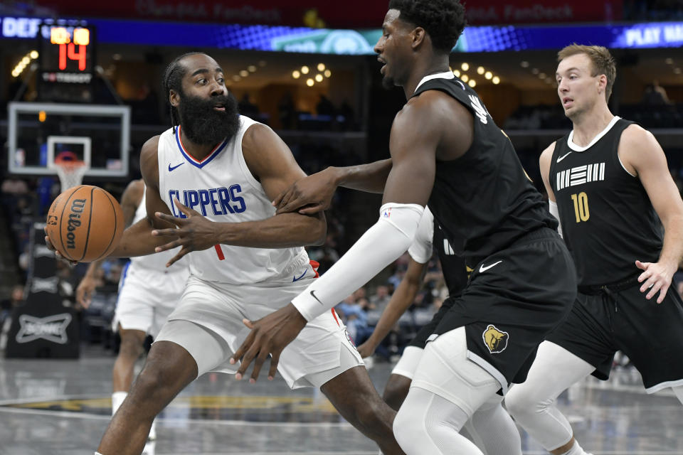 Los Angeles Clippers guard James Harden (1) is defended by Memphis Grizzlies forward Jaren Jackson Jr. during the first half of an NBA basketball game Friday, Feb. 23, 2024, in Memphis, Tenn. (AP Photo/Brandon Dill)
