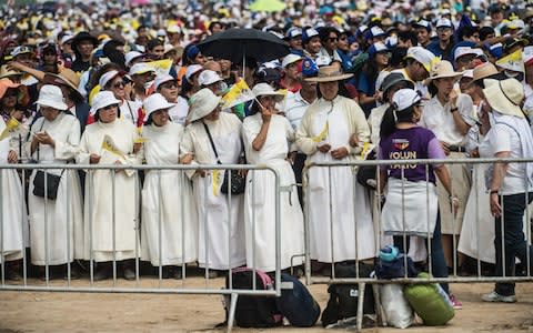 Nuns wait for the arrival of Pope Francis at the Las Palmas air base in Lima on January 21, 2018. Pope Francis was preparing to wrap up his Latin American trip with a mass at the air base where a million faithful were expected to hear him speak. - Credit: AFP