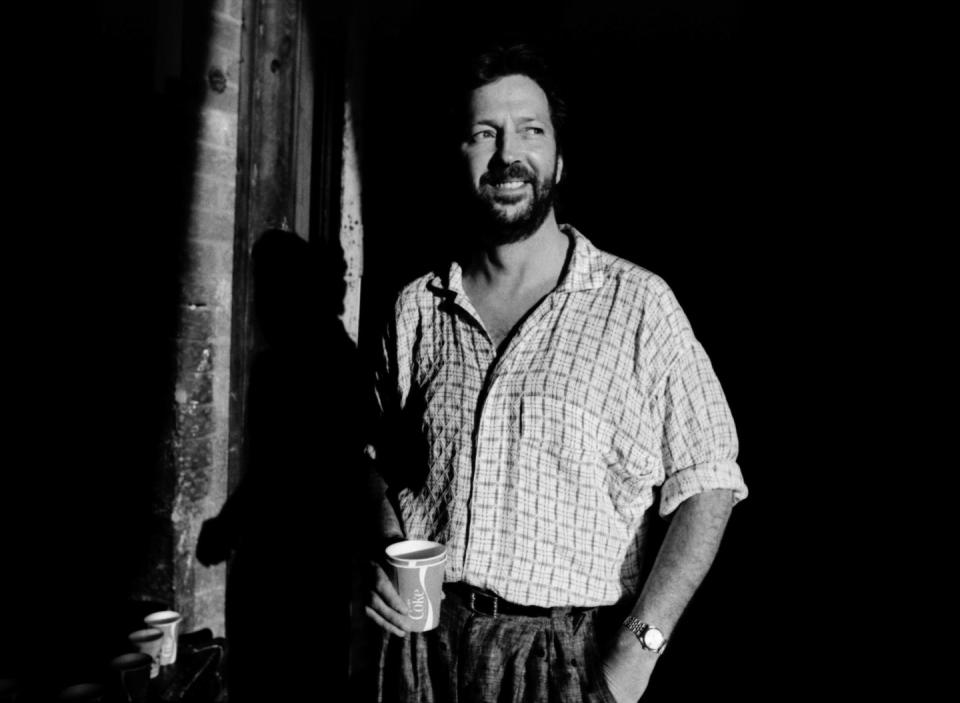 <p>A calm, cool, and collected Eric Clapton enjoys a drink while backstage at a concert in 1984. At the time, Clapton was both recording his hit album <em>Behind the Sun</em> and dealing with marital problems with his first wife, Pattie Boyd. </p>