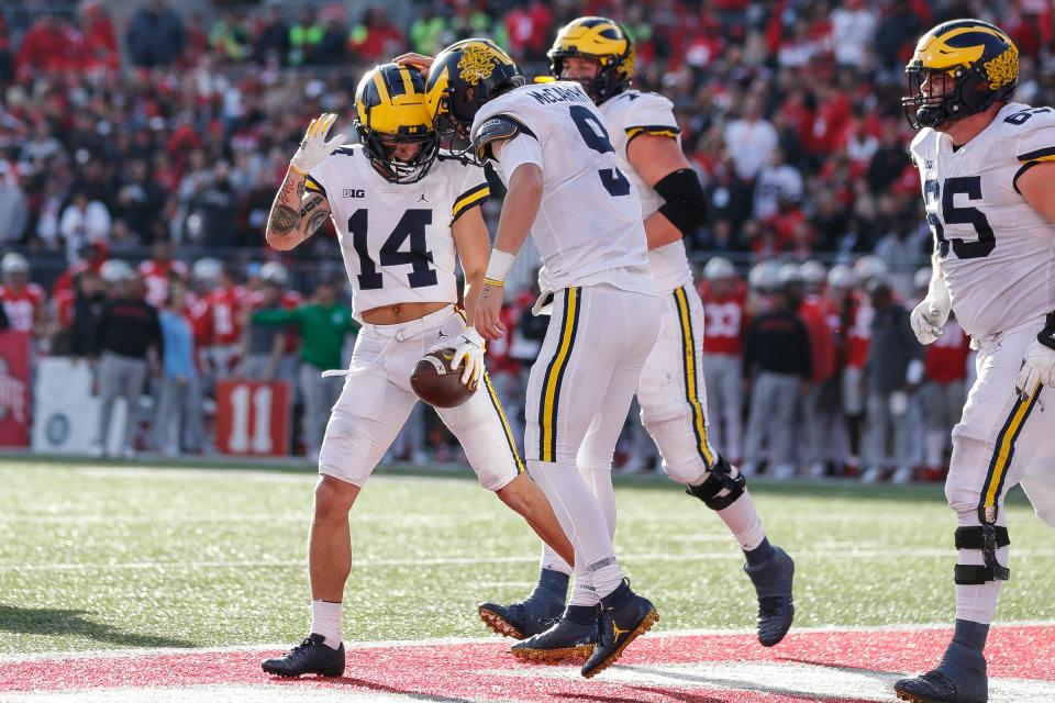 Michigan quarterback J.J. McCarthy (9) celebrates his touchdown against Ohio State with wide receiver Roman Wilson (14) during the second half at Ohio Stadium in Columbus, Ohio, on Saturday, Nov. 26, 2022.