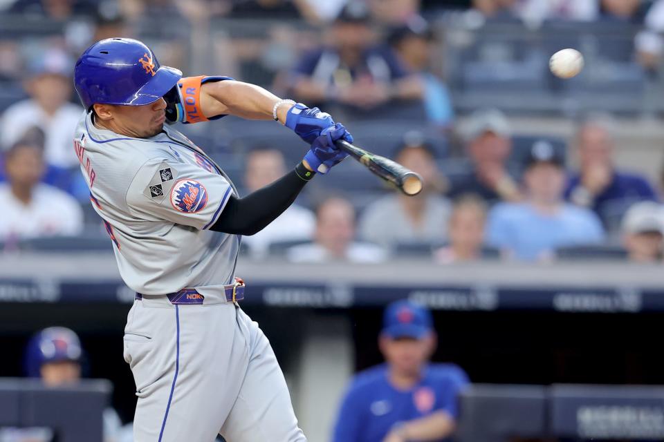 New York Mets center fielder Tyrone Taylor (15) hits a solo home run against the New York Yankees during the third inning on July 24, 2024, at Yankee Stadium.