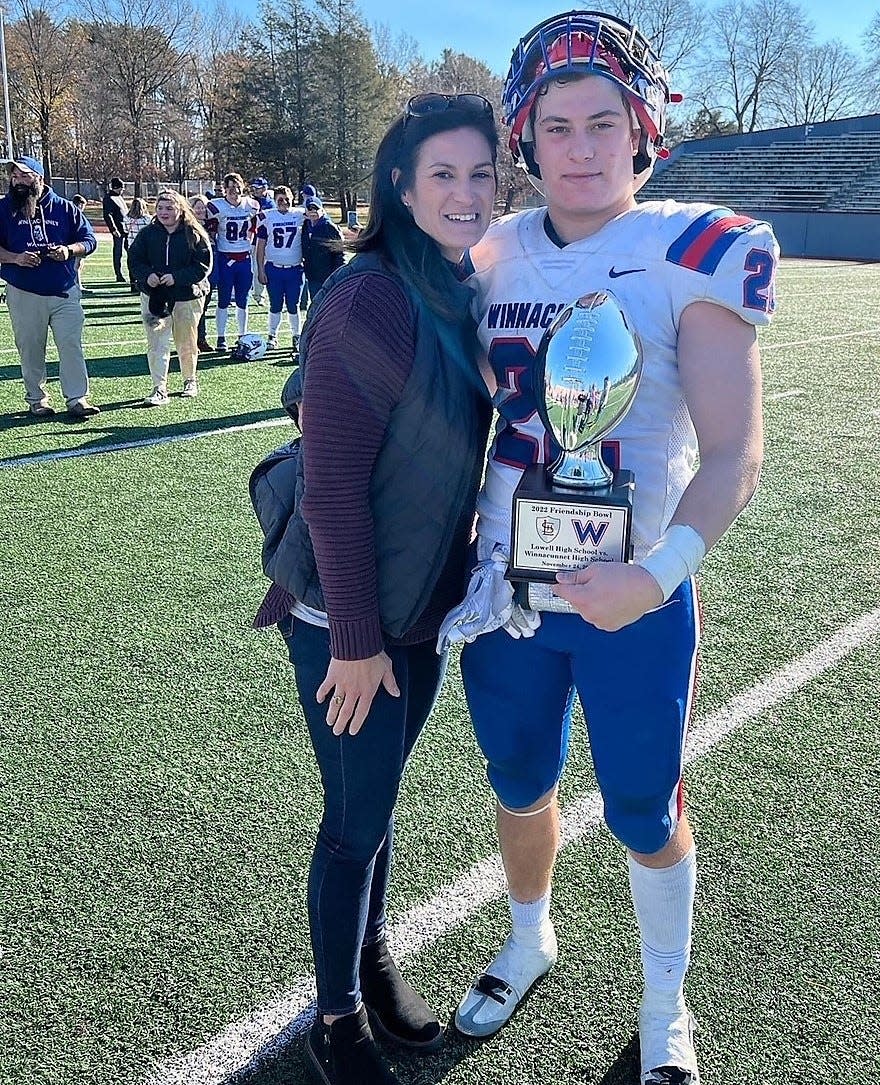 Winnacunnet High School senior Frankie Brown, who threw for a touchdown and ran in a 2-point conversion, stands with his mom, Erica, after Winnacunnet's 8-7 win over Lowell (Massachusetts) High School in Thanksgiving's inaugural Friendship Bowl at Edward D. Cawley Memorial Stadium in Lowell.