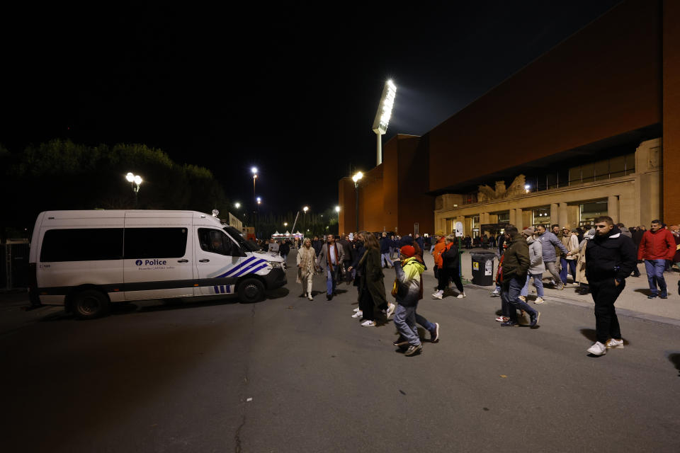 Supporters walk away from the venue after suspension of the Euro 2024 group F qualifying soccer match between Belgium and Sweden at the King Baudouin Stadium in Brussels, Monday, Oct. 16, 2023. The match was abandoned at halftime after two Swedes were killed in a shooting in central Brussels before kickoff. (AP Photo/Geert Vanden Wijngaert)