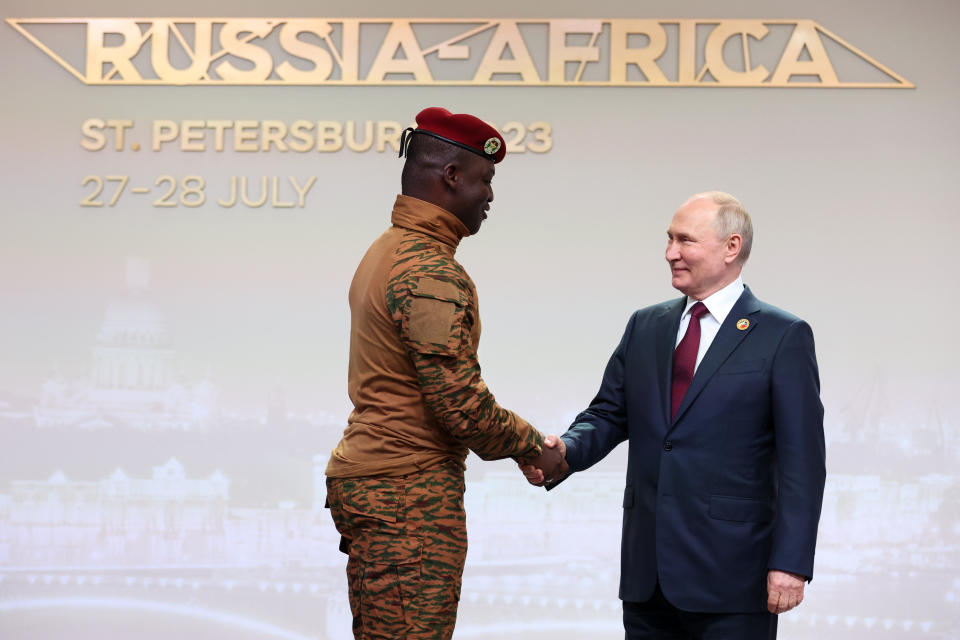 Burkina Faso's Capt. Ibrahim Traore, left, and Russian President Vladimir Putin shake hands before an official ceremony to welcome the leaders of delegations to the Russia Africa Summit in St. Petersburg, Russia, Thursday, July 27, 2023. Not everyone is hostile to the coups in Niger and other African nations in the past few years that have worried the West. In the "family photo" for last week's Russia-Africa Summit, Russian President Vladimir Putin stood next to Ibrahim Traore, the young military officer who seized power in Burkina Faso in September. (Sergei Bobylev/TASS Host Photo Agency Pool Photo via AP)