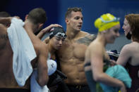 Caeleb Dressel, of the United States, right, comforts teammate Torri Huske after they finished fifth in the mixed 4x100-meter medley relay at the 2020 Summer Olympics, Saturday, July 31, 2021, in Tokyo, Japan. (AP Photo/David Goldman)