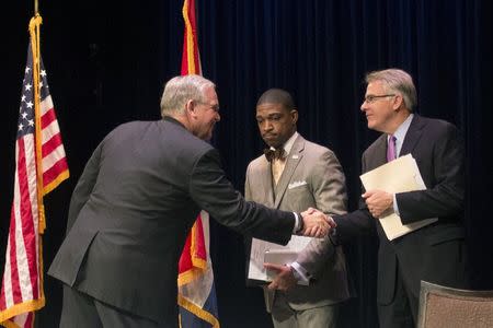 Missouri Governor Jay Nixon (L) greets Richard McClure (R) and Reverend Starsky Wilson, the co-Chairs of the Ferguson Commission, after introducing them in St. Louis, Missouri November 18, 2014. REUTERS/Adrees Latif
