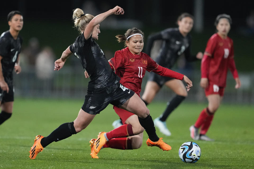 New Zealand's Erin Nayler, left, and Vietnam's Thi Thao Thai compete for the ball during the New Zealand and Vietnam warm up match ahead of the women's World Cup in Napier, New Zealand, Monday, July 10, 2023. (AP Photo/John Cowpland )