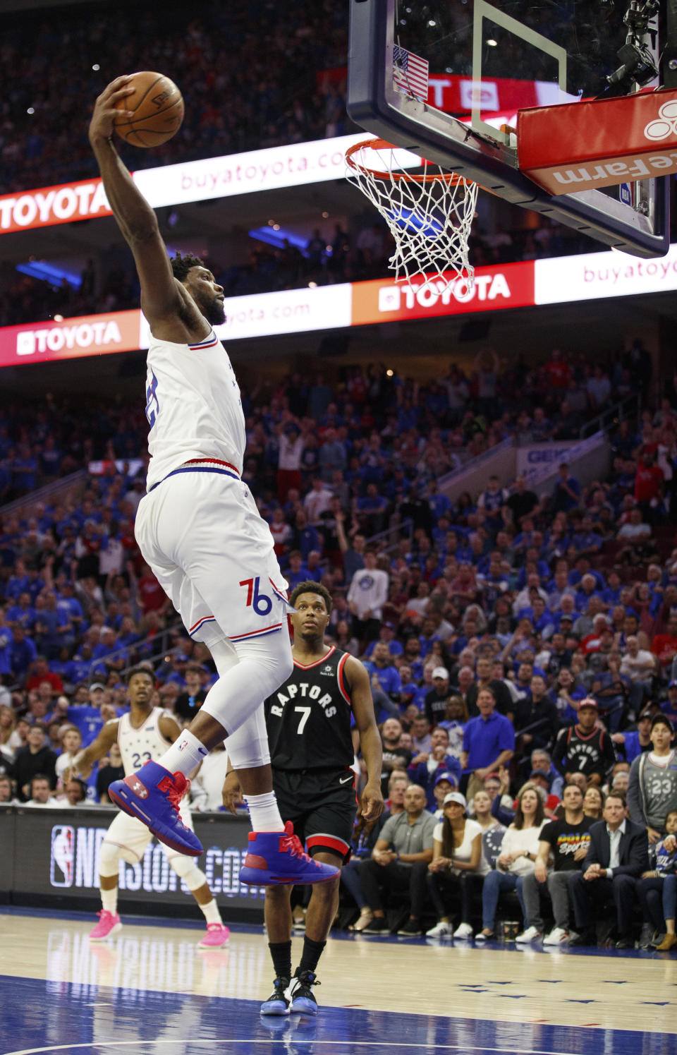 Philadelphia 76ers' Joel Embiid goes up for the dunk as Toronto Raptors' Kyle Lowry watches during the second half of Game 3 of a second-round NBA basketball playoff series Thursday, May 2, 2019, in Philadelphia. The 76ers won 116-95. (AP Photo/Chris Szagola)