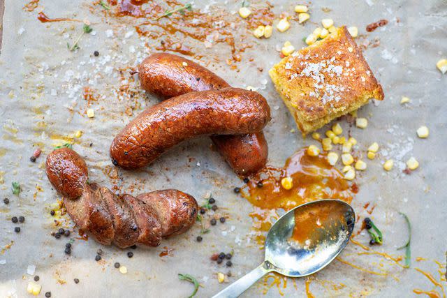 <p>Michelle VanTine/Courtesy of Drinking Pig BBQ</p> Corn bread and smoked sausages from Drinking Pig BBQ.