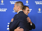 Aleksander Ceferin, President of UEFA, welcomes Philipp Lahm, former soccer player and tournament director of the European Championship, during the draw for the groups to qualify for the 2024 European soccer championship in Frankfurt, Germany, Sunday, Oct.9, 2022. (Arne Dedert/dpa via AP)