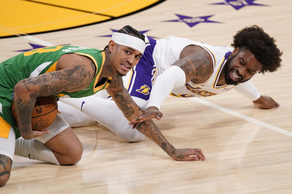 Utah Jazz guard Jordan Clarkson, left, and Los Angeles Lakers guard Wesley Matthews scramble for a loose ball during the first half of an NBA basketball game Saturday, April 17, 2021, in Los Angeles. (AP Photo/Mark J. Terrill)