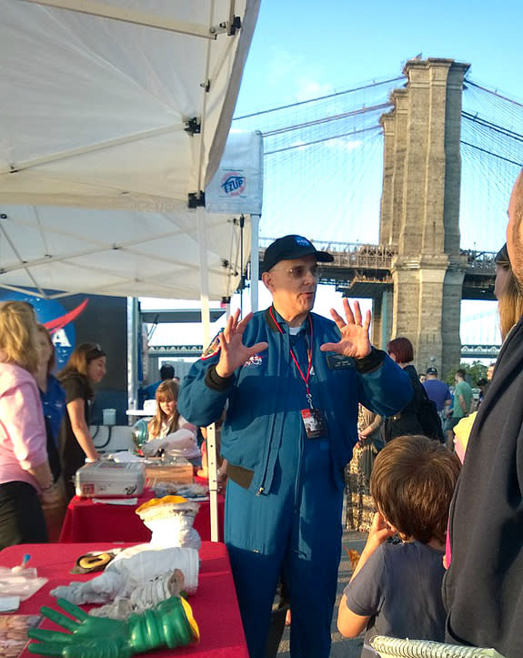 Astronaut Lee Morin, speaking at Brooklyn Bridge Park at the 2015 World Science Festival in New York, describes life in space to a group of awestruck kids