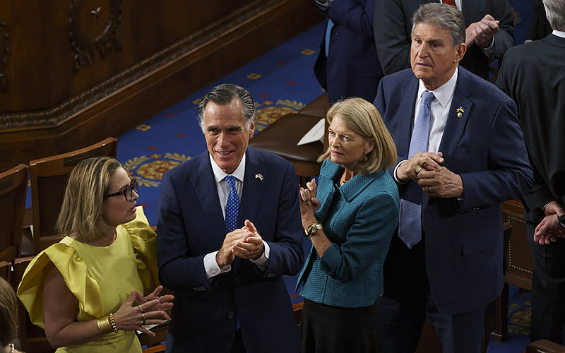 Sens. Kyrsten Sinema (I-Ariz.), Mitt Romney (R-Utah), Lisa Murkowski (R-Alaska) and Joe Manchin (D-W.Va.) are seen before President Biden’s State of the Union address to a joint session of Congress on Feb. 7. <em>Greg Nash</em>