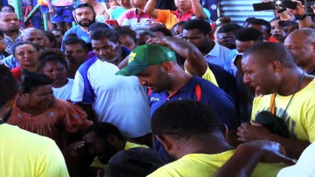 PNG coach Marum brings his players along to grieve the loss of Ottio. Pic: EMTV