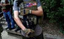 FILE PHOTO: A member of a militia stands near a rally in Charlottesville Virginia